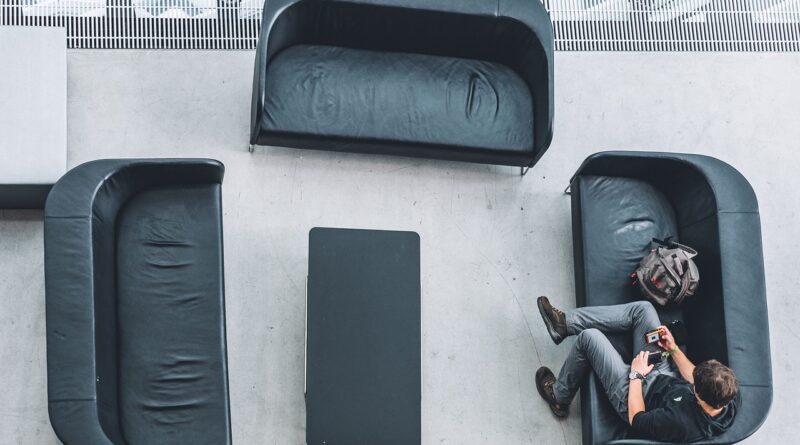 black, sofa, couch, living room, table, furniture, house, interior, people, man, guy, sitting, blue room, blue table, blue interior, blue couch