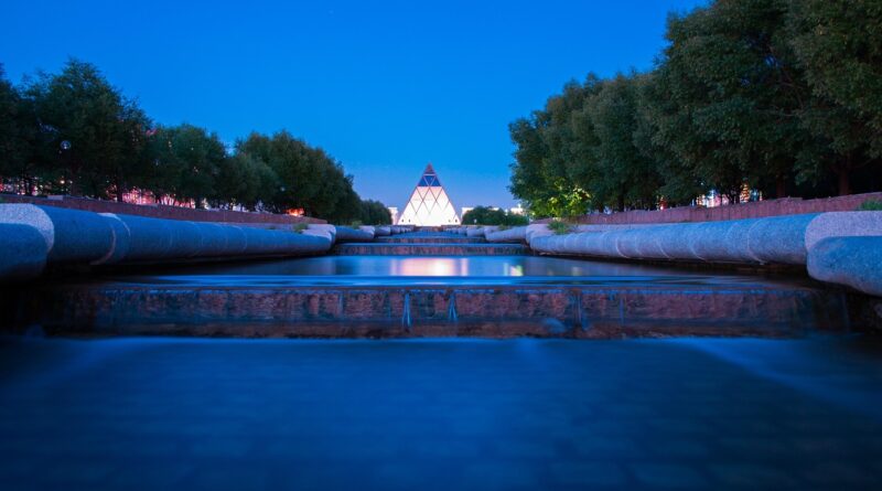 the palace of peace and accord, astana, kazakhstan, asia, pyramid, night sky, night, blue, trees, the park, water, stream, reflection, light, artificial, presidential park, evening, calmness, beautiful, norman foster, summer, tourism, nature, architecture, capital, clear