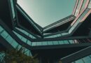 modern architecture, urban view, architectural design, multi-angular building, long angle view, blue sky, office building, modern city, abstract architecture, minimalist aesthetics, skyscraper, light reflection, urban architecture, geometric patterns, window facade, urban environment, building structure, outdoor view, building construction, modern offices