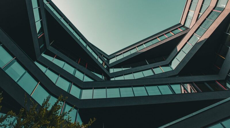 modern architecture, urban view, architectural design, multi-angular building, long angle view, blue sky, office building, modern city, abstract architecture, minimalist aesthetics, skyscraper, light reflection, urban architecture, geometric patterns, window facade, urban environment, building structure, outdoor view, building construction, modern offices