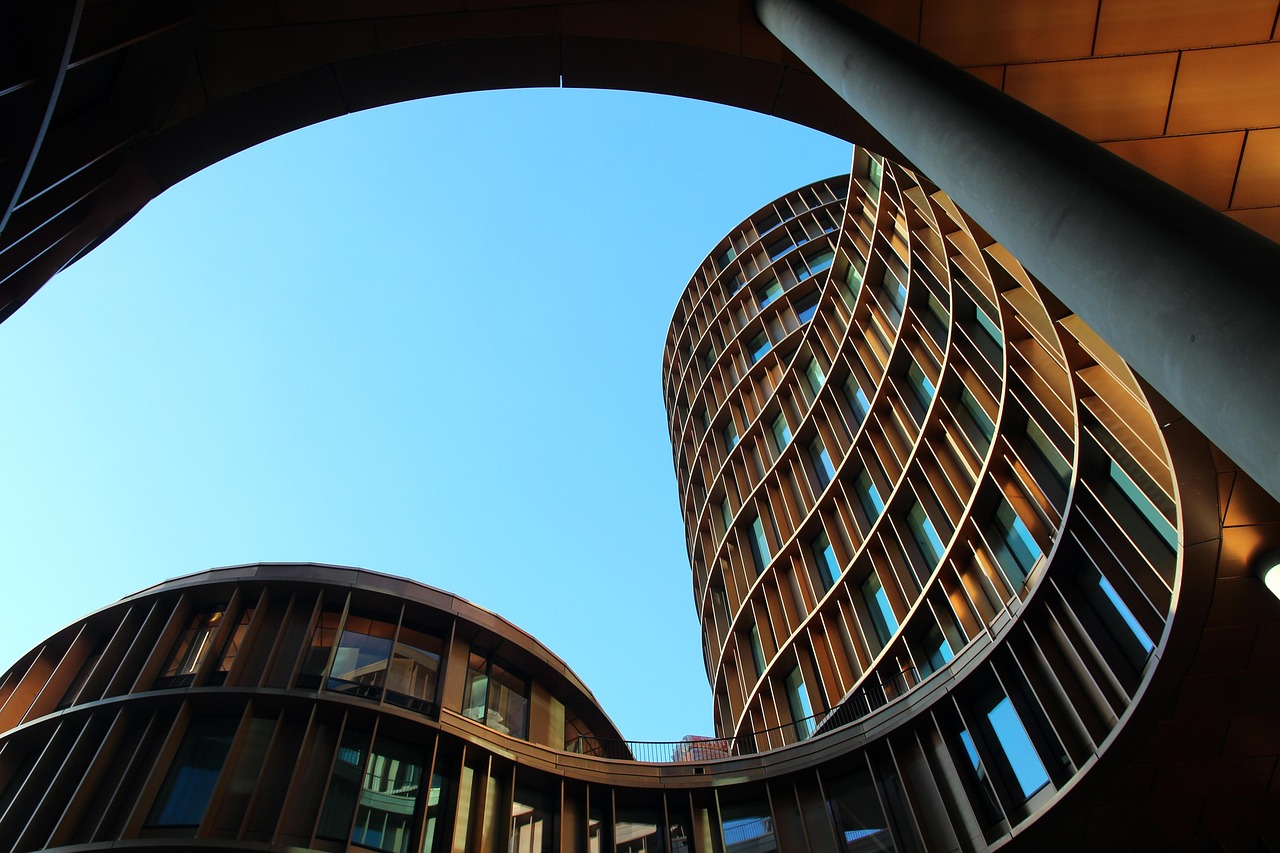 Contemporary building design explained through form, performance and place image architecture, tower, building, red brown, low angle shot, blue, sky, construction, perspective, site, modern, construction art, facade, nature, glass, round, build, house, design, contemporary architecture, blue sky, modern architecture