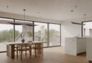 modern kitchen, dining table, wooden floor, minimalist design, pendant lights, large windows, bright interior, open space, simple furniture, scandinavian style, interior design, stylish dining room, sliding doors, architectural design, natural lighting, kitchen with view, clean lines, outdoor terrace